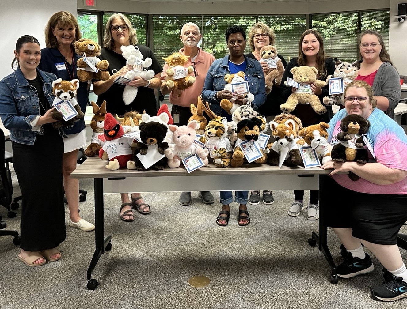 Staff members display their completed Comfort Buddies